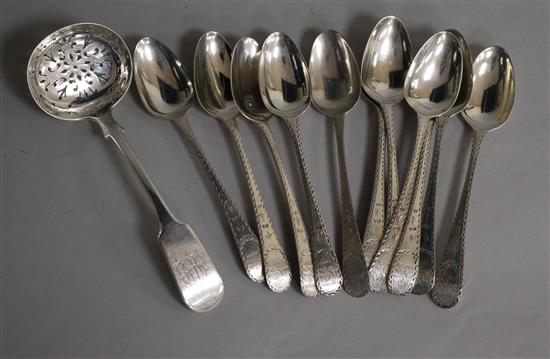 Eleven George III bright cut engraved silver teaspoons, Godbehere & Wigan, London, 1787 and a later silver sifter spoon.